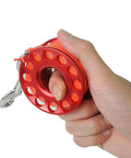 Hand holding 98ft Diving Finger Reel With Line And Snap For Scuba Wreck Cave Tech Diving Snorkeling Kayak Anchor And Surface Marker Buoy