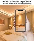 Hand holding a smartphone in a bedroom highlighting no flicker soft lighting