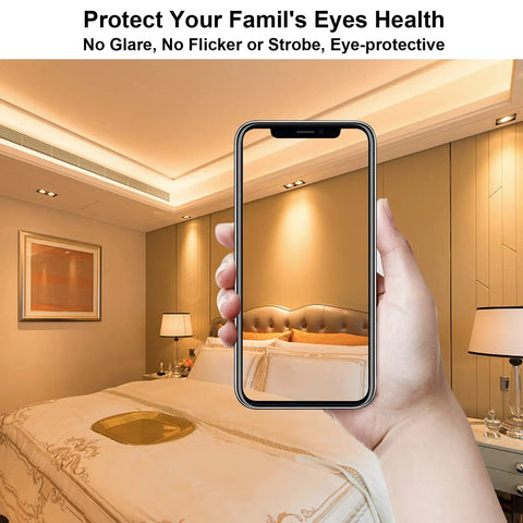 Hand holding a smartphone in a bedroom highlighting no flicker soft lighting
