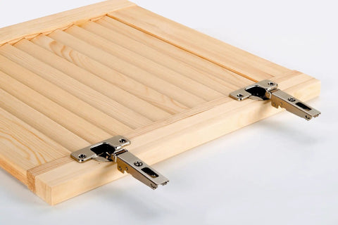 Pro Grade Forstner Drill Bit Set With Custom Hinge Mounting Template Built To Bore Dead Center Twenty Six To Thirty Five Mm Holes shown on a wooden cabinet door with metal hinges.