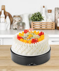 Mirror Surface Motorized Turntable Display Stand With 360 Degree Rotary Motion And Adjustable Speed showcasing a decorated cake in a kitchen.