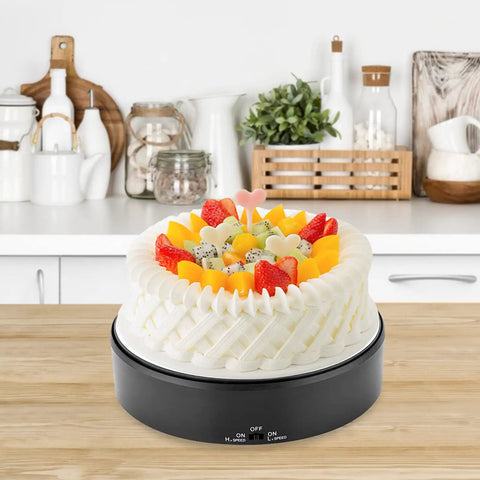 Mirror Surface Motorized Turntable Display Stand With 360 Degree Rotary Motion And Adjustable Speed showcasing a decorated cake in a kitchen.