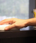 Hand using Twin Pack 4x5 White Terry Cloth Staining Pad With SuperTuff Sponge for smooth stain application on dark wood surface