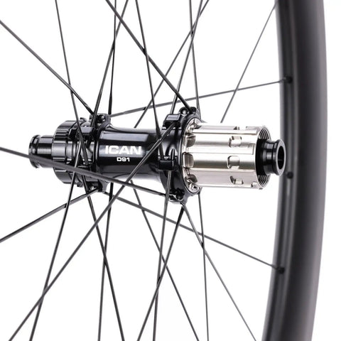 Close-up of hub and spokes on G27 700C Carbon Gravel Wheelset with 50mm Aero Rim and 27mm Inner Width, disc brake compatible.