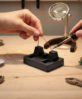 Hands-Free Electric Wire Welding Fixture With Adjustable Clamps in use while soldering wires on a workbench.