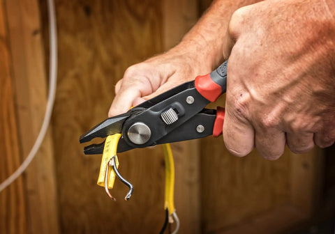 Close-up of 2 In 1 Combo Linesmans Pliers And Wire Stripper With Dual Material Handles cutting and stripping wires, Black CCP8V