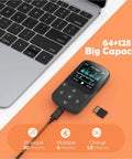 64GB MP3 Player With Clip For Sports A65 Bluetooth 5 Point 3 Music Player next to a laptop with SD card and charging cable