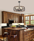 Rustic Black Wood Drum Chandelier With Eight Lights 23.25 Inch Diameter in kitchen, hanging above island with wooden cabinets.