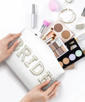 Hands holding Bride Patch Makeup Bag With White Pearl Rhinestones For Women, showing makeup products around.”} 反馈 έχω αντιμετωπίσει αυτήν την κατάσταση και πάλι! 這種情況，我以前也碰到過！ I have faced this situation before! What do you want to learn from this experience?