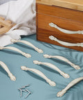 Vintage Alloy Cabinet Pulls 12 Sets White Drawer Handles 3.7 Inch 96mm Hole Centers displayed with screws on blue surface