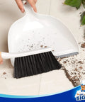 Portable Dustpan and Brush Set With Bamboo Handle in White for quick cleanups demonstrating debris collection on floor