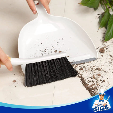 Portable Dustpan and Brush Set With Bamboo Handle in White for quick cleanups demonstrating debris collection on floor