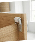 White Nylon Sliding Door Guide Wheels With Brake For Furniture Cabinet Tracks Heavy Duty Drawer Roller Casters mounted on a wooden cabinet door.