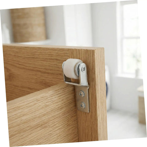 White Nylon Sliding Door Guide Wheels With Brake For Furniture Cabinet Tracks Heavy Duty Drawer Roller Casters mounted on a wooden cabinet door.