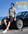 Man with X8 APEX EV Tire Inflator Portable Air Pump next to electric car under blue sky