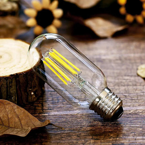 Dimmable T45 LED Edison Bulbs 2700K Warm White, 6W Filament Tubular Bulbs, 60W Equivalent, E26 Base on wooden surface
