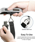 Hands using Hassle Free Travel Luggage Scale Portable Digital Hanging Baggage Scale With 110 Lb Capacity Lightweight Suitcase Weight Scale Battery Included Silver.