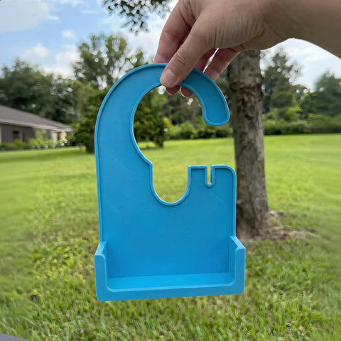 Hand holding a blue Pump Holder For Enteral Feeding Pump No Tools Needed Snap Fit 3D Printed Carrier Stand outside.