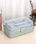Clear 3 Layer Plastic Dividing Storage Box With Adjustable Spacers Portable Handle Craft Organizer in Haze Green on desk.