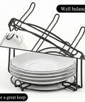 Tea Cup Holder For Countertop And Display Stand Foldable Metal Rack with saucers and a cup organized on the rustproof iron frame.