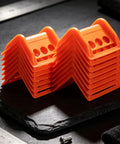 Orange 20 Pack Plastic Flatbed Edge And Corner Protectors stacked for Trucks Heavy Duty Ratchet Strap and Winch Guard use