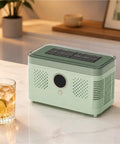 Sleek Countertop Ice Maker With Zero Sweat One Touch Operation And Smooth Self Cleaning Design Blazing Fast Cube Production For Weekend Hangouts Home Bars Or Office Chill Areas Ultra Compact on kitchen counter with drink.