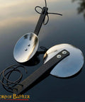 Pair of 16 Gauge Steel Rondels With Genuine Leather Straps for Elbows and Knees Armor on reflective surface