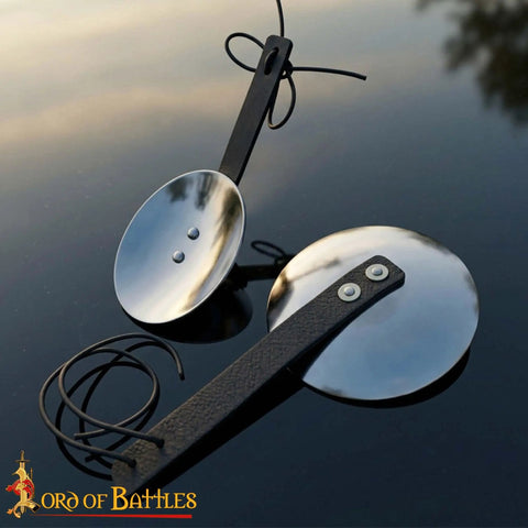 Pair of 16 Gauge Steel Rondels With Genuine Leather Straps for Elbows and Knees Armor on reflective surface