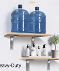 Stainless Steel L Brackets For Wall Shelves Heavy Duty Floating Shelf Supports holding two water bottles and toiletries on wood shelves.