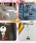 "Two Piece Golf Keychains Set In Zinc Alloy Durable Golf Cart Key Ring With Golf Themed Design A Fun Souvenir For Players And Fans Black And Red Dope Gift For Golfers And Collectors shown on bag, belt, keys, and water cup."