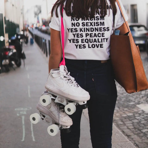 Person holding 4 Piece PU Double Row Roller Skate Wheels With Bearings For Quad Skating in city street