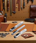 Pro Grade 3 Piece Leather Hole Punch Set With Steel Hollow Punches For Grommets 1/4 Inch, 3/8 Inch, 1/2 Inch shown on workshop table