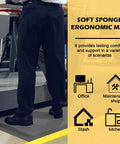 Person standing on 3 X 5 Foot Anti Fatigue Floor Mat Extra Thick Fifteen Sixteenths Inch Ergonomic Diamond Plate Heavy Duty Non Slip Industrial Grade Mat To Ease Leg And Back Pain Durable Gray in office setting.