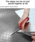 Heavy Duty Cuttable Non Slip Electrical Insulating Mat Waterproof Rubber Safety Flooring being cut with scissors for customization.