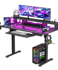 Level Up Your Gaming Space With This Electric Standing Desk That Offers Smooth Height Adjustment Customizable Rgb Lighting And Fast Usb Charging For Cool Setups. Black desk with dual monitors, RGB lighting, keyboard, and gaming setup.