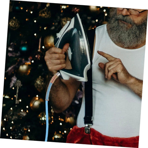 Heavy Duty PTFE Steam Hose For Steam Irons in use, showing lightweight, flexible design during ironing near a decorated Christmas tree.