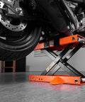 Beefy 1100 Lbs Motorcycle Lift Center Scissor Jack in use lifting rear wheel of motorcycle in garage setting
