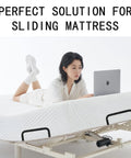 Heavy Duty Mattress Retainer Brackets To Lock Your Bedding Down On Platform Adjustable Or Rv Camper Frames Easy Install Slide Stopper Rails on mattress with a person using a laptop.