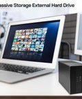 Top Shelf Dual Bay Usb 3.0 External Hard Drive Yields Knockout 44Tb Storage for desktop setup with laptop and images on screen.