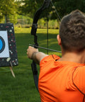 Archer aiming at a target, using Beefy 4.2mm Arrow Nocks 30 Pack White Insert Nocks Replacement For Hunting And Target Archery