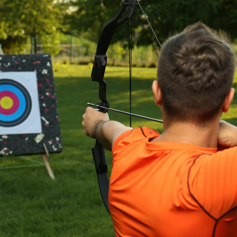 Archer aiming at a target, using Beefy 4.2mm Arrow Nocks 30 Pack White Insert Nocks Replacement For Hunting And Target Archery