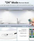 Remote control for puck lights with charging station 4 pack, motion sensor under cabinet closet lighting in kitchen setting.