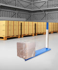 Badass Manual Stretch Film Dispenser For Pallet Wrap And Box Rolling No Sweat Design, used in a warehouse with wrapped box.