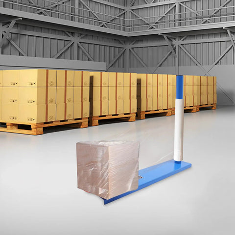 Badass Manual Stretch Film Dispenser For Pallet Wrap And Box Rolling No Sweat Design, used in a warehouse with wrapped box.