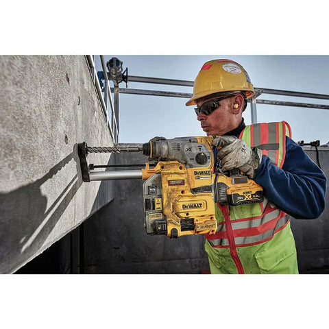 Worker using Heavy Duty Cordless 20V Brushless Rotary Hammer Drill Sick Power Bad Boy on concrete wall.