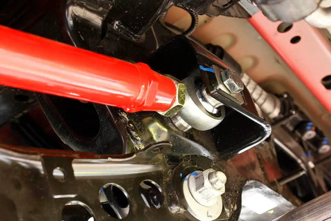 Close-up of Rear Adjustable Toe Rod Kit With Spherical Rod Ends and Red Powder Coat for Chevy Camaro 2016.