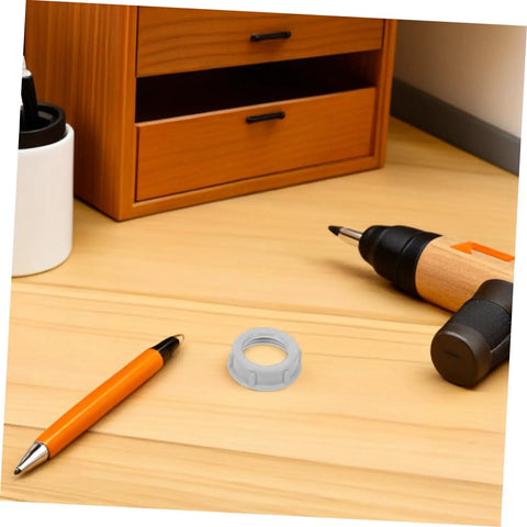 No Fuss 3/4 Inch Plastic Insulating Bushings 100 Pack on a wooden desk with a pen and drill.