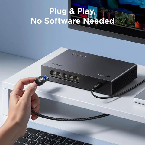 Five Port 2.5Gb Ethernet Switch with five 2.5Gb ports, shown in use on a desk setup, featuring plug and play unmanaged network connectivity.