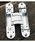 Invisible Hinge 180 Degree Zinc Alloy for Hidden Folding Doors cross hidden hinges on rough concrete surface