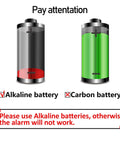 Illustration showing alkaline and carbon batteries with a note: 'Please use Alkaline batteries, otherwise the alarm will not work.'
